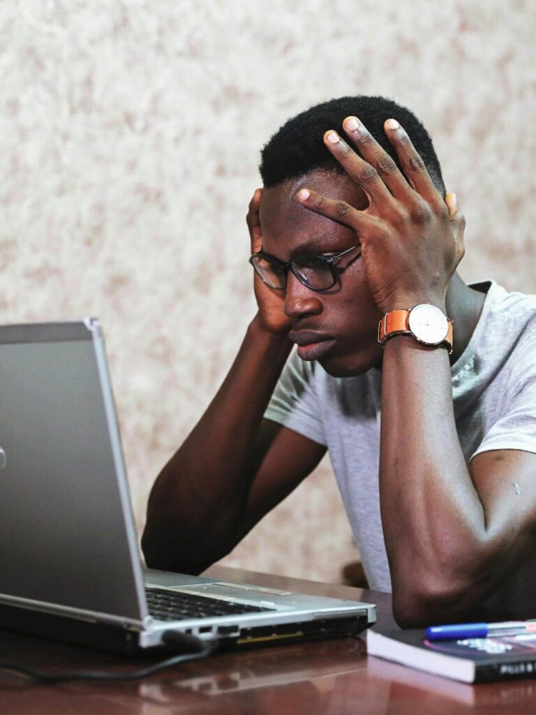 confused guy in front of laptop